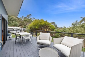 A deck with outdoor furniture, a table, and chairs. - Blue Haven at Aireys (Aireys Inlet)