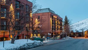 A multi-story hotel with a brick facade and warm lighting. - Ski-In/Ski-Out at Shadow Ridge (Park City)