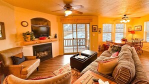 A cozy living room with a fireplace, a television, and a large sofa. - Newly Renovated! Fox Bay Retreat at Deer Valley (Heber City)