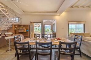 Enjoy meals in this spacious dining area with a long table and comfortable seating for six.