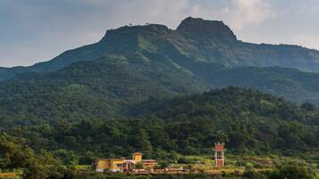 A mountain landscape with a small building featuring a tower.