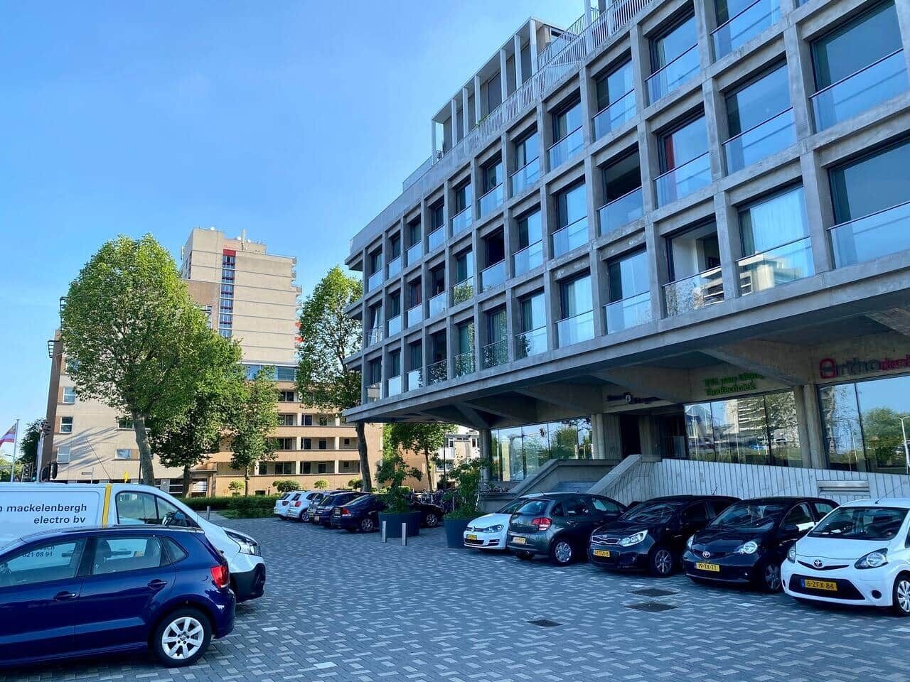 A modern building with a parking lot.