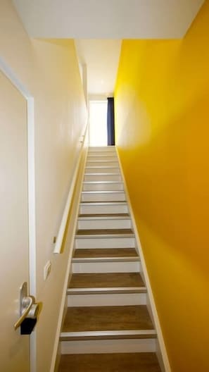 Stairs lead to a residential space with a window at the top.