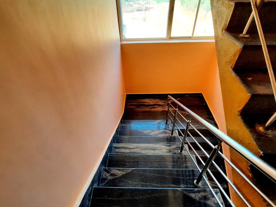A staircase with metal railings leading to a landing.