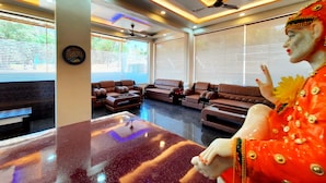 Un interior moderno con sofás de cuero, una mesa de mármol y un ventilador de techo.