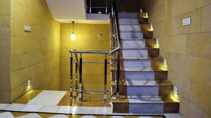 A staircase with marble steps and metal railings, leading to an upper floor. - Chirag Haveli - Near Golden Fort (Jaisalmer)
