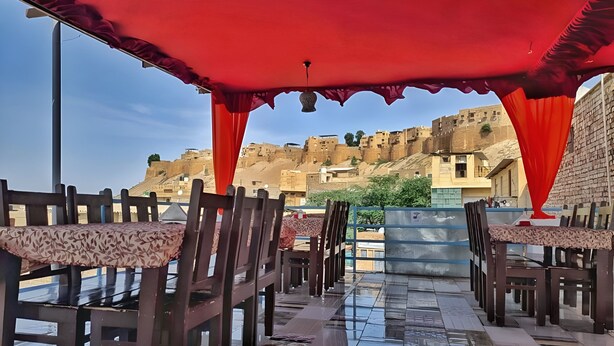 A restaurant with a terrace overlooking a historic cityscape. - Chirag Haveli - Near Golden Fort (Jaisalmer)