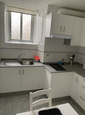 Fridge, microwave, stovetop, coffee/tea maker