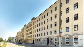 A multi-story building with a row of windows on the ground floor, likely a hotel or office building.