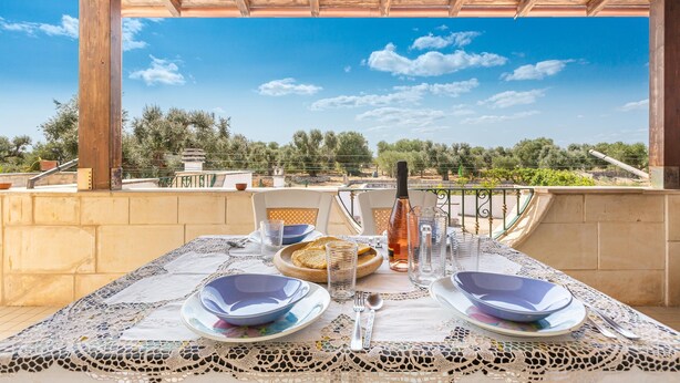 A table set for two with a view of a landscape. - 3634 Villa Dolce - App1 by Barbarhouse (Ostuni)