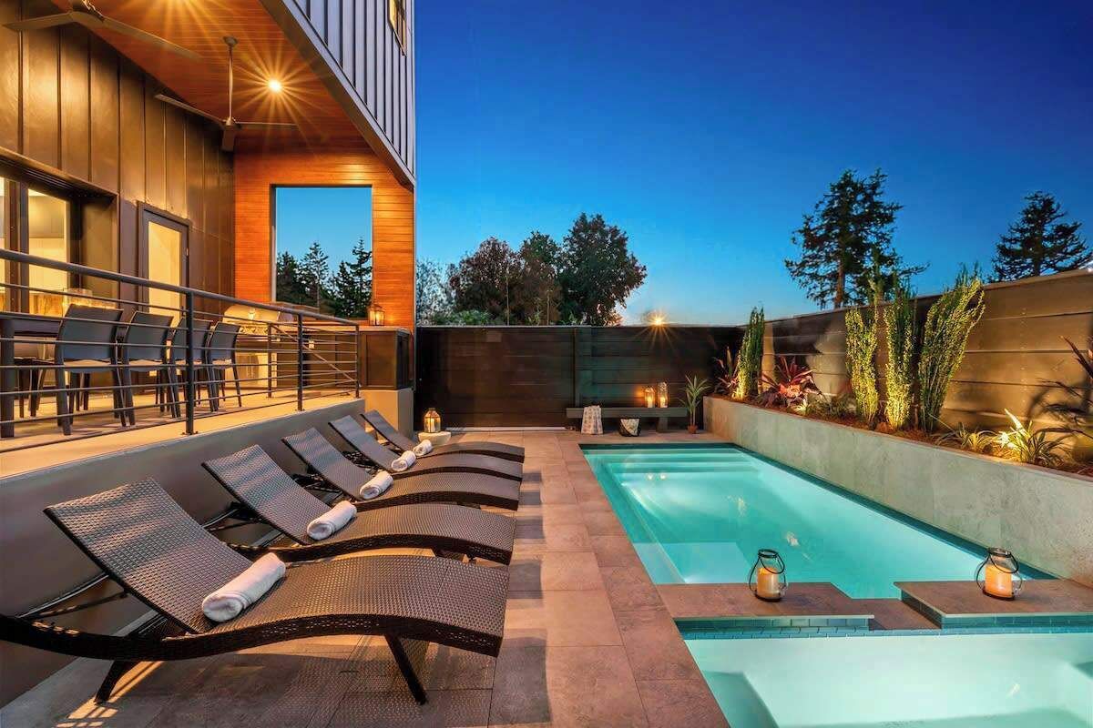 A poolside area with lounge chairs and a swimming pool.