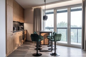 Enjoy meals and socializing in this kitchen with a central island, large window, and bar-style seating area.
