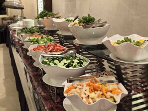 A buffet with various food items including vegetables, seafood, and salads. - Al Ebaa Hotel (Makkah)