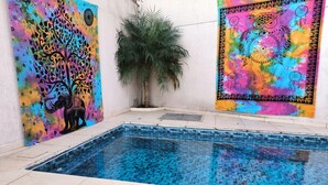 A swimming pool with colorful artwork on the walls.