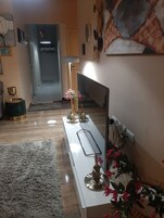 Family Suite | Living area | 40-inch Smart TV with digital channels, books, stereo