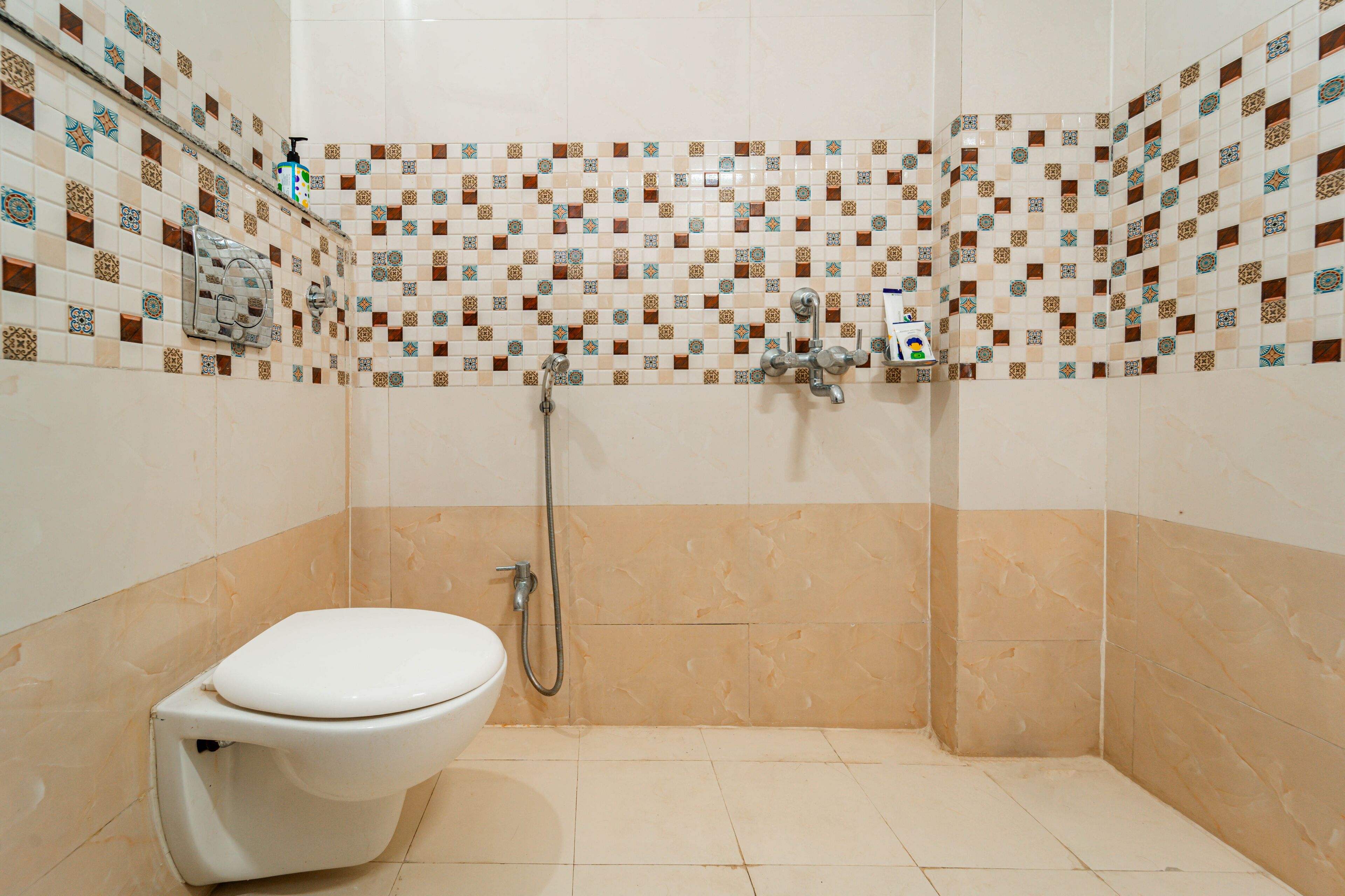 A bathroom with a shower, toilet, and tiled walls.