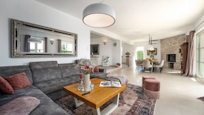 A modern living room with a grey sofa, a wooden coffee table, and a large mirror. - Villa Bincila Exclusive for 12 persons, pool, 6 bedrooms, pets allowed, garage (Labinci)