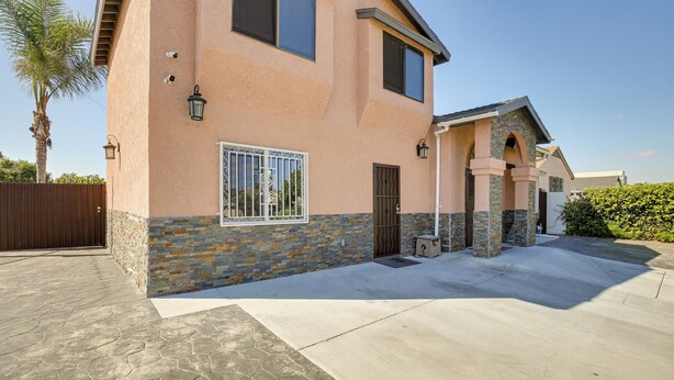 A two-story house with a stone base and a peach-colored upper section. - 3 Mi to Sofi Stadium! Hidden Gem in Hawthorne (Hawthorne)