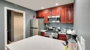 A kitchen with wooden cabinets, a stainless steel refrigerator, a microwave, a stove, and a sink. - 3 Mi to Sofi Stadium! Hidden Gem in Hawthorne (Hawthorne)
