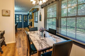 Enjoy meals in this stylish dining area with a marble table and comfortable seating, surrounded by beautiful artwork.