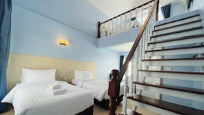 A hotel room with two beds, a wooden staircase, and a light blue wall. - The Autumn Creek ChiangRai (Chiang Rai)