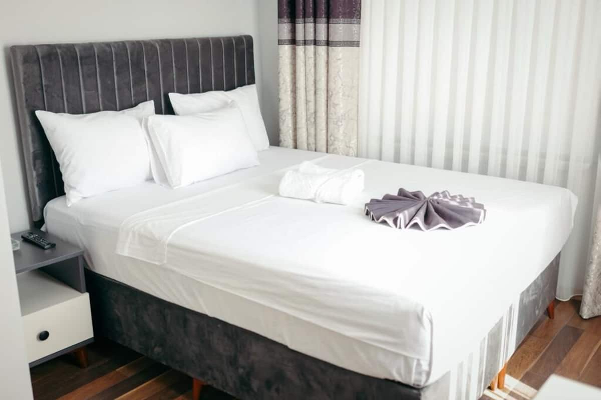 Desk, laptop workspace, bed sheets