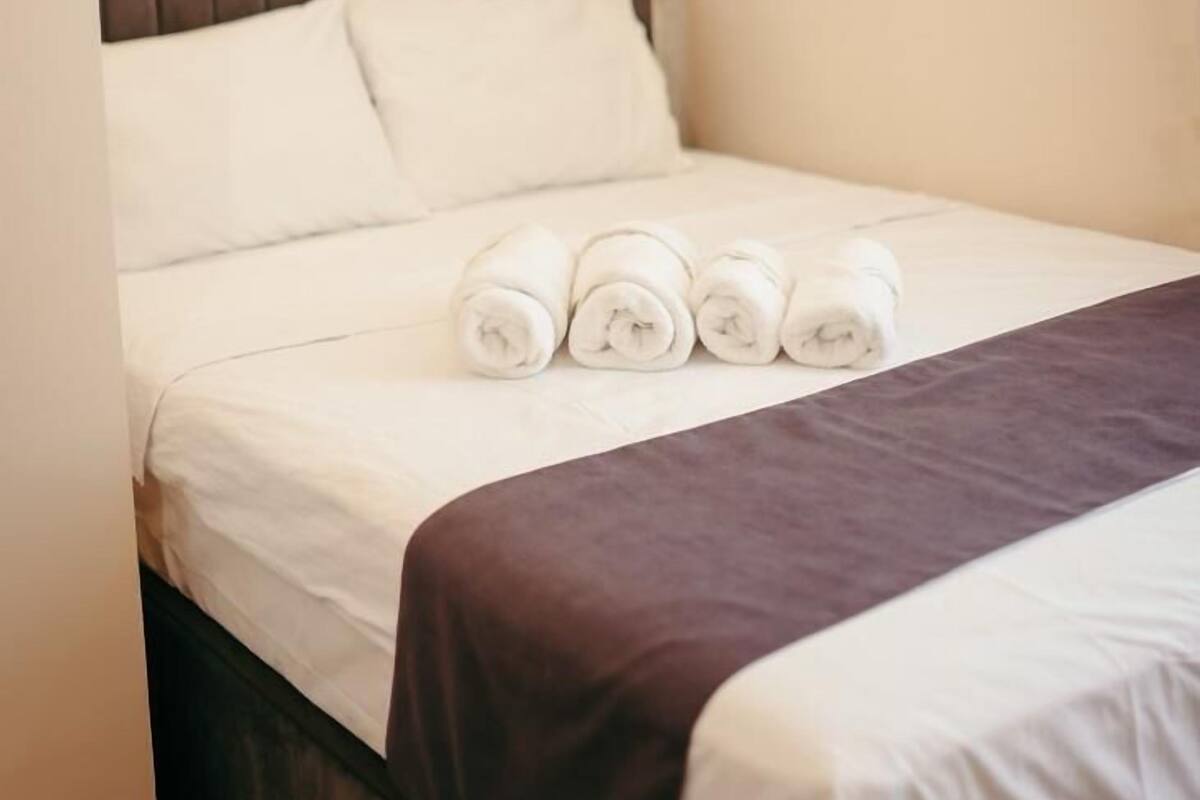 Desk, laptop workspace, bed sheets