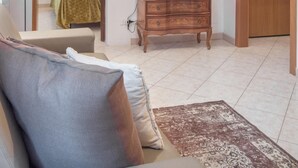 A room with a bed, a wooden dresser, a television on the wall, and a door. - Venice Grand Canal Style Apt 1 by Wonderful Italy (Venice)