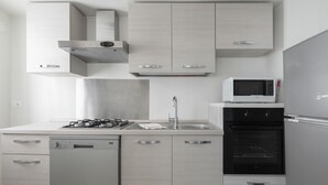 A modern kitchen with a dishwasher, stove, microwave, and oven. - San Marco Style Canal View Apt 1 by Wonderful Italy (Venice)