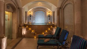 A spa area with stone columns, a mosaic wall, and lounge chairs. - Studio Priv Balcony PBonito Sunset Beach
 (Paraiso Escondido)