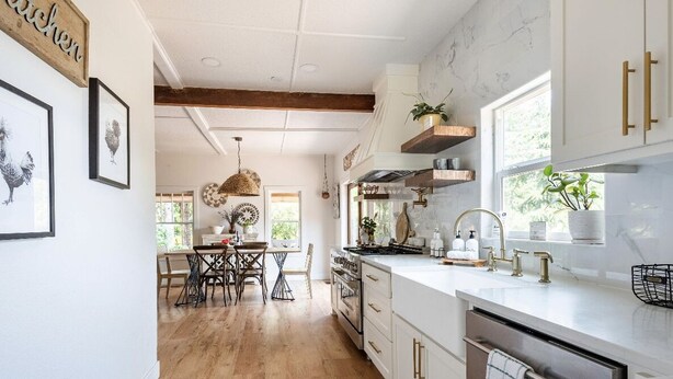 A modern kitchen with white cabinets, a wooden dining table, and a large window. - Farmhouse on wine scenic route, alpacas and hot tub. Pet friendly.  (Hillsboro)