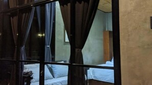 A room with a large window, curtains, and a bed. - Villa Overlooking the Bay at Crystal Cove (Sipalay, Negros Occidental)