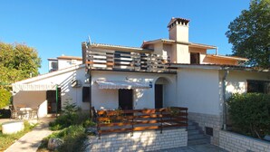 A two-story house with a patio area, outdoor seating, and a small garden. - Apartment 1778/20511 (Istria - Kukci), 2000m from the beach (Kukci)