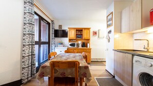 A compact kitchen with a microwave, coffee maker, and wooden cabinets. - Apt 4 ppl near the ski runs, terrace (Morillon)