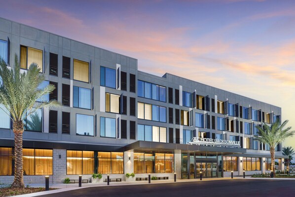 A modern hotel building with a flat facade, large windows, and a sign reading "ACHTEL JACKSONVILLE". - AC Hotel Jacksonville St Johns Town Center (Jacksonville)