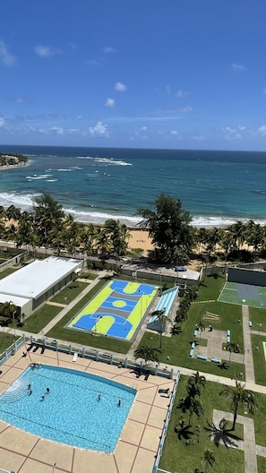 Enjoy a scenic ocean view from the property's outdoor seating areas, which offer a large pool and a basketball court.