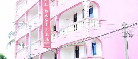 A multi-story hotel with balconies and a prominent vertical sign reading "HOTEL BASILIA".