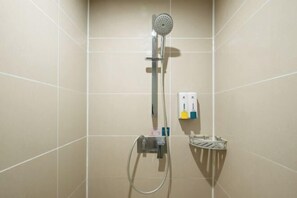 A shower area with a handheld showerhead, a wall-mounted control panel, and a small shelf with toiletries. - Jindu Hotel (Guangzhou Railway Station Sanyuanli Subway Station Branch) (Guangzhou)
