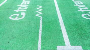 A green bike lane with white text and symbols.