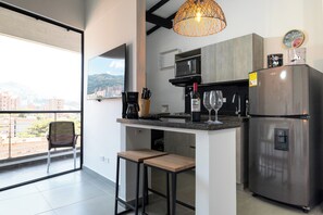 Fridge, microwave, coffee/tea maker, cookware/dishes/utensils