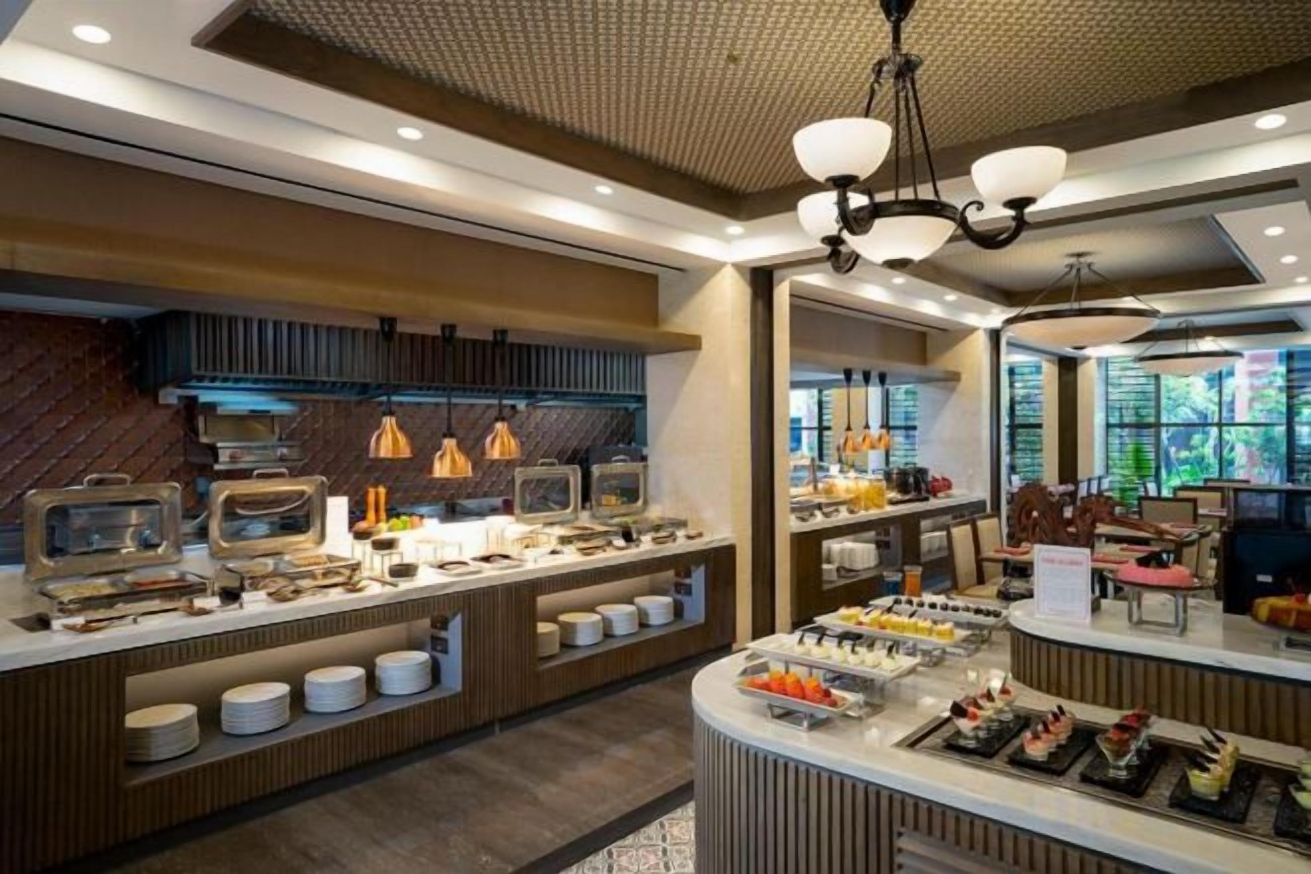 A buffet area with multiple food stations and a central serving counter.