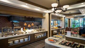 A buffet area with multiple food stations and a central serving counter.