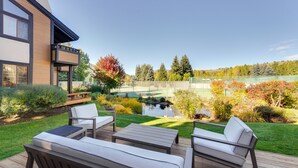 A deck with outdoor furniture, a pond, and a view of a lake and trees. - Sun Valley Condo w/ Furnished Patio: Near Skiing! (Sun Valley)