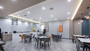 A modern dining area with marble flooring, contemporary furniture, and recessed ceiling lighting. - Elong ME Hotel (Binhai High-Speed Railway Station) (Tianjin)