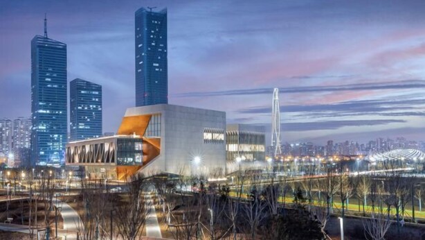 A modern urban area with high-rise buildings, a stadium, and a bridge. - Elong ME Hotel (Binhai High-Speed Railway Station) (Tianjin)