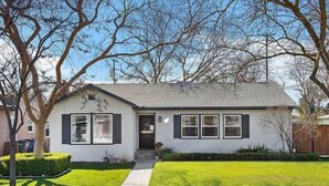 A single-story house with a front porch, a small front yard, and a sidewalk leading to the house. - Clean&Cozy 3 bedroom 2 bath home No cleaning fees
 (Fresno)