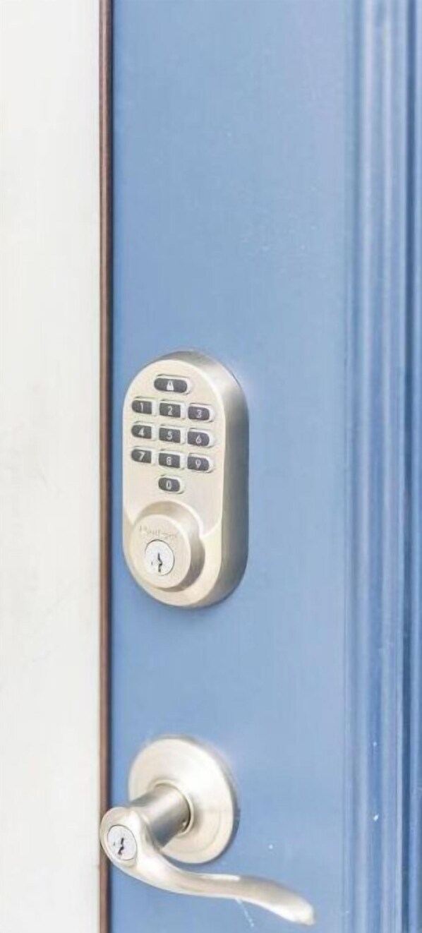 A door with a numeric keypad lock and a keyhole. - Clean&Cozy 3 bedroom 2 bath home No cleaning fees
 (Fresno)