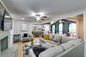 A modern living room with a sofa, coffee table, and a fireplace.