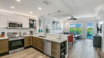 Full-size fridge, toaster, cookware/dishes/utensils, cleaning supplies