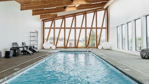 An indoor swimming pool with wooden beams and large windows. - Dune Cabin - The Dune Cabin is well-appointed and uniquely designed and comfortably sleeps 6 guests. Private bedroom with queen bed, open loft with twin beds, and dinette that converts to a full size bed (Coos Bay)